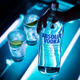Lifestyle image of bottle in front of backlit bar top