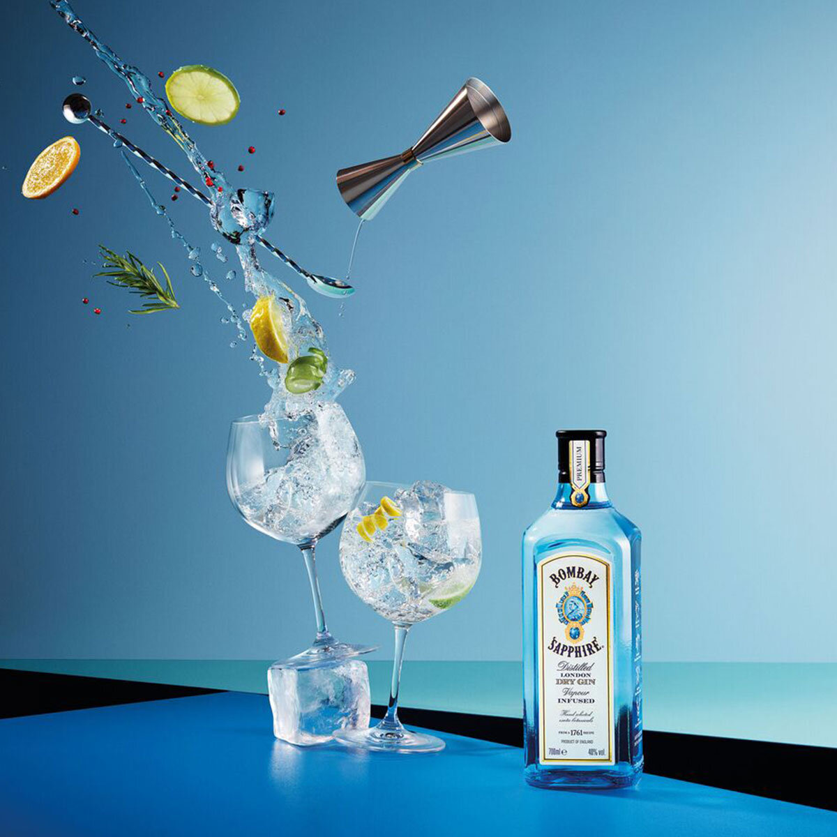 Bombay Sapphire, with glasses and slices of lemon and lime