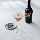 Lifestyle image of bottle with cocktail